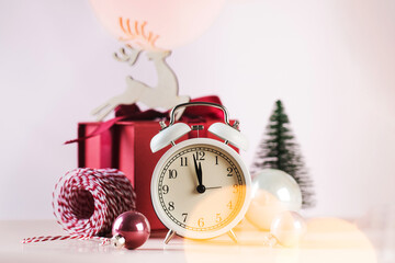 Christmas composition with alarm clock baubles and gift box. Copy space.