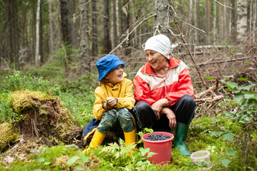Grandmother and grandson spend time together in the forest.