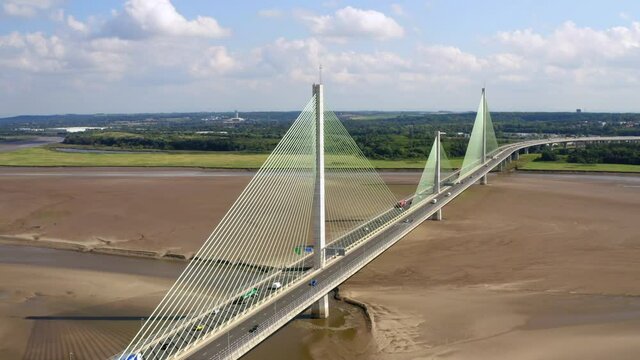 Mersey gateway suspension bridge drone shot. long slow cinematic parallax rotation showing the full length of the new liverpool based bridge.