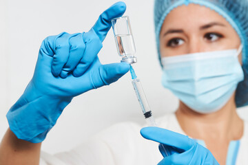 Female doctor injecting injection vaccine, close-up