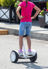 The girl is riding a gyro scooter