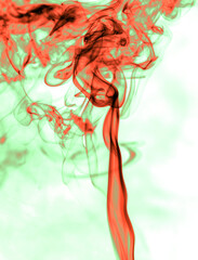 Red and green smoke on a white background.