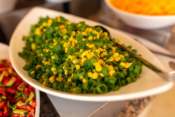 A platter of corn with vegetables in a restaurant.