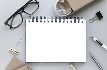 office desk with notepad, stationery magnifier, pen, pencil, glasses