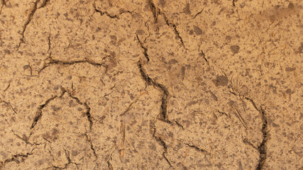 An old wall made of clay which begins to crack - Clay wall texture background