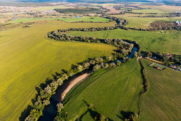 Picturesque landscape with a winding river between fields, aerial view. Protva river in the countryside, Zhukovsky district, Kaluzhskiy region, Russia