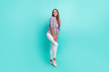 Fototapeta na wymiar Full size photo of cute millennial brunette lady stand wear shirt trousers sneakers isolated on cyan background