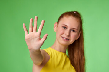 young redhead pretty girl showing stop gesture