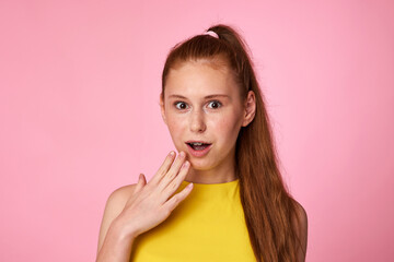 surprised teenager girl on green background. Human emotions