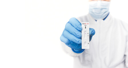 The doctor showing Covid-19 negative test result of the antigen rapid test kit on white background and copy space,Coronavirus infectious protect concept