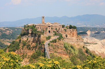 panorama of the village called Civita di Bagnoregio in central Italy which rises above a mountain connected by a very long bridge