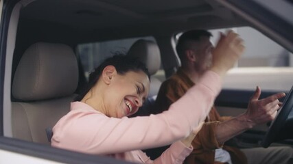 Cheerful husband and wife dancing, celebrating purchase of the car, success