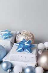 Fototapeta na wymiar Christmas present and decorations close up on grey