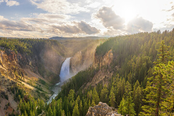 Amazing sunset at the Lower Falls in the Grand Canyon of the Yellowstone National Park - obrazy, fototapety, plakaty