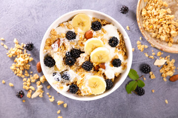bowl of muesli, milk and fresh fruits
