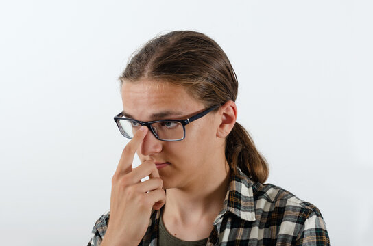 Young man thouch his glasses