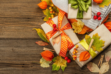 Fototapeta premium Zero waste gift concept with autumn design. Warm sweaters, fall leaves, thematic decor