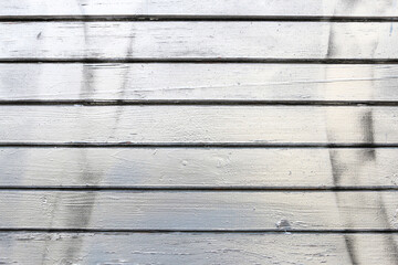 Wooden wall made of planks painted silver.
