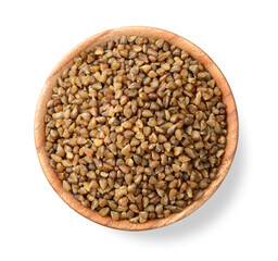uncooked buckwheat in the wooden plate, isolated on the white background, top view