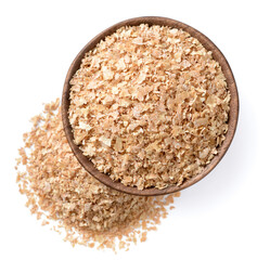 uncooked wheat bran in the wooden bowl, isolated on the white background, top view