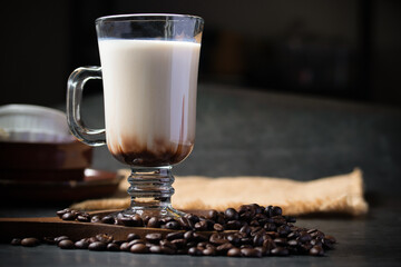 Fresh milk coffee mixed with cold chocolate on black background with copy space