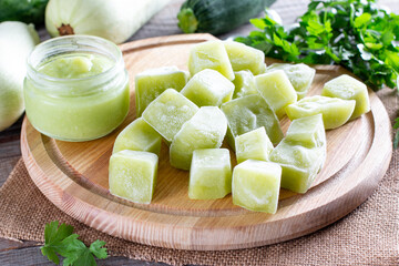 Frozen zucchini puree cubes on a cutting board on a table. Baby food. Frozen Food Concept.