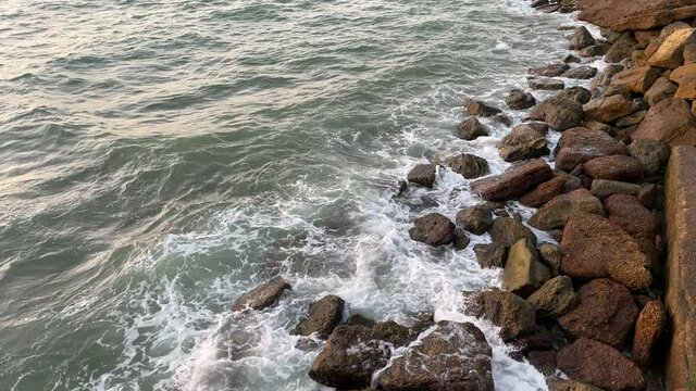 Sea waves crashing on rock stones on the shore