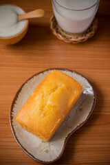 Orange cake with fresh milk on wooden floor