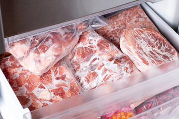 Raw frozen meat. Raw pork chops in the freezer.