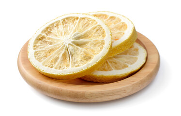 dried lemon slices in the wooden plate, isolated on the white background