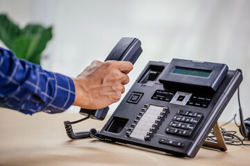 Communication support, call center and customer service help desk. telephone devices with VOIP headset in office.Customer service support (call center) concept.