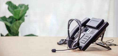 Communication support, call center and customer service help desk. telephone devices with VOIP headset in office.Customer service support (call center) concept.