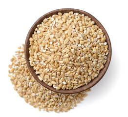 close up of raw steel cut oats in the wooden bowl, isolated on white, top view