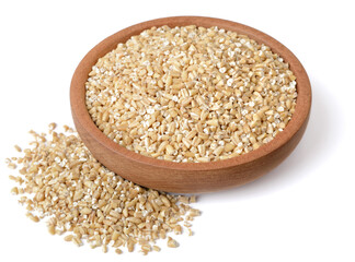 close up of raw steel cut oats in the wooden plate, isolated on white. (large depth of field, taken with tilt shift lens)