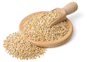 raw steel cut oats in the wooden scoop and plate, isolated on the white background