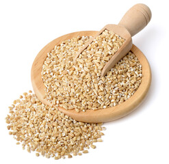 raw steel cut oats in the wooden scoop and plate, isolated on the white background