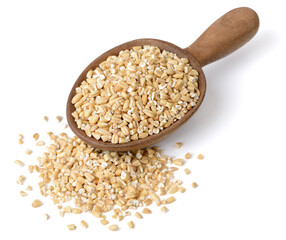 raw steel cut oats in the wooden spoon, isolated on the white background