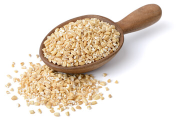 raw steel cut oats in the wooden spoon, isolated on the white background