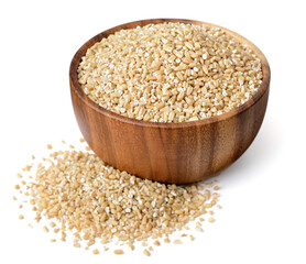 uncooked steel cut oats in the wooden bowl,  isolated on the white background