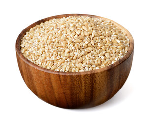 uncooked steel cut oats in the wooden bowl,  isolated on the white background