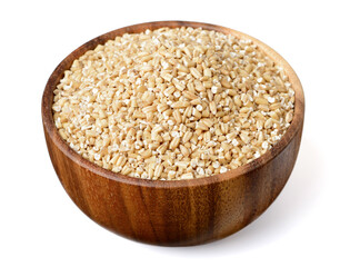 uncooked steel cut oats in the wooden bowl,  isolated on the white background