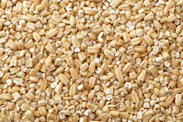 food backgroud of uncooked steel cut oats, top view
