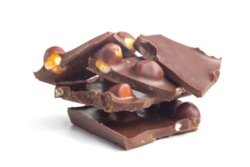Chocolate with filberts piles on white background. Sweet food object photo