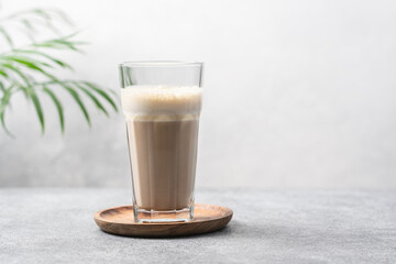 Glass Cup of bulletproof coffee  on white background with copy space. Ketogenic keto diet coffe blended with coconut oil and butter