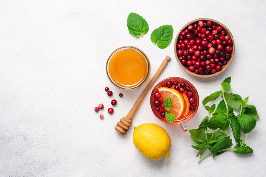 Hot tea with wild cranberries, lemon, honey and mint. Winter healthy drink for immunity boosting