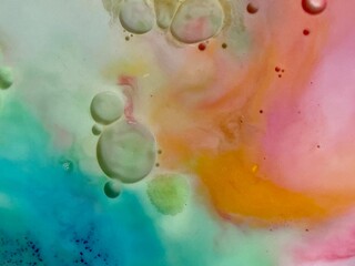 blue pink yellow ink swirl with oil bubble in liquid  background 