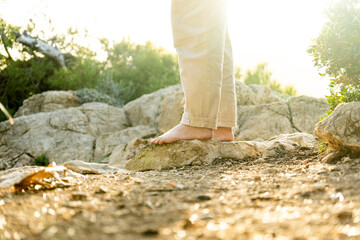 bare feet on rock with golden light