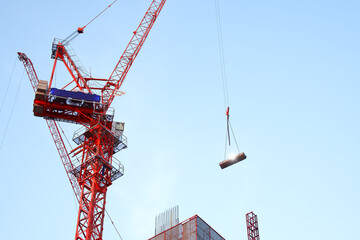 Cranes high-rise, Construction site, On backdrop of blue sky morning with copy space, Industrial machine engine and mechanical outdoor workplace, Development land and buildings residential project.