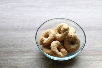 Bowl of biscuits on wooden table. Selective focus.