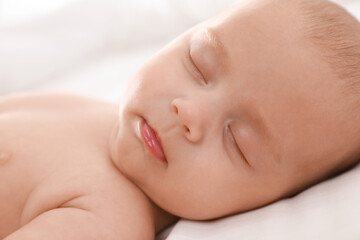 Fototapeta na wymiar Cute little baby sleeping on bed, closeup
